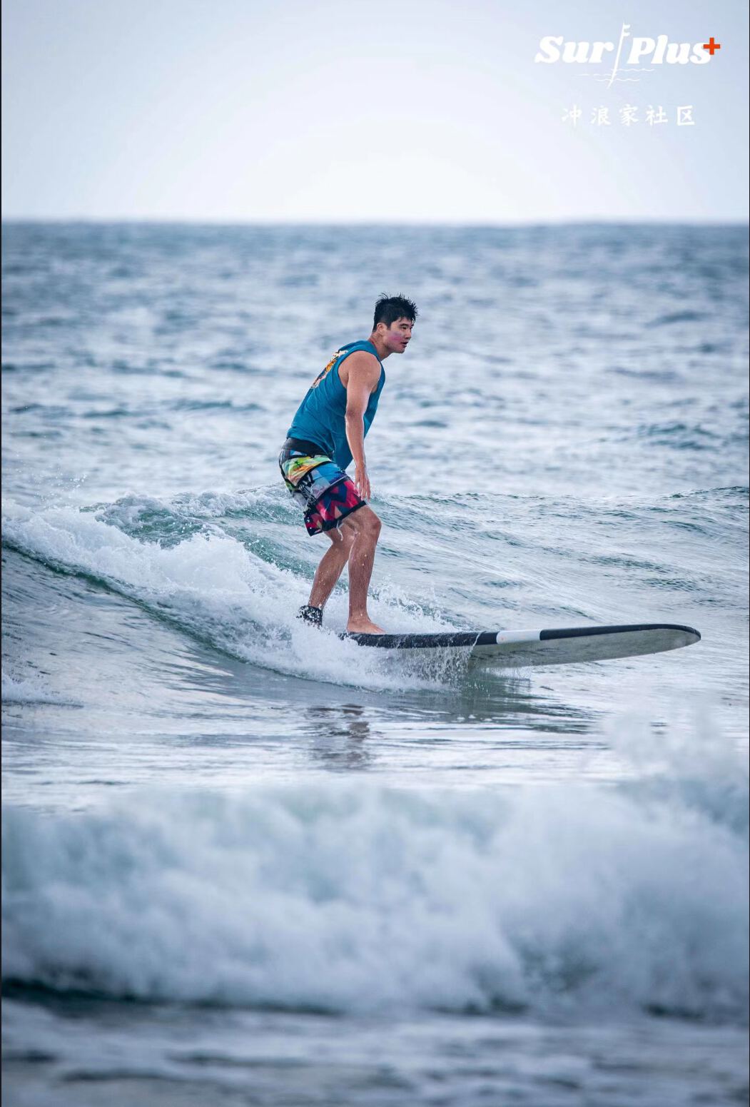 A longboard learner riding along a clean wave
